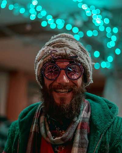  Man with glasses smiling and looking at camera at night