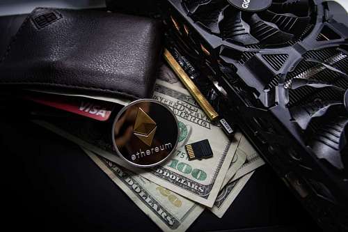 Wallet with dollars and an ethereum coin