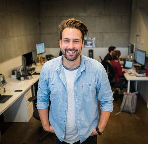close-up of a man in front of his office mates