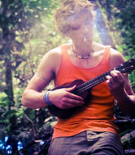 smoking-activity Man playing a little guitar