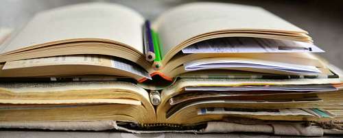 close-up of a pair of books with pencils as bookmark
