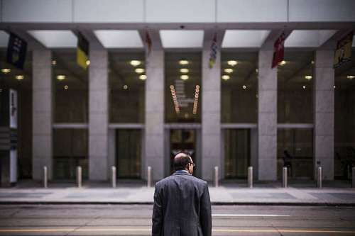 businessman standing at the door of a bank