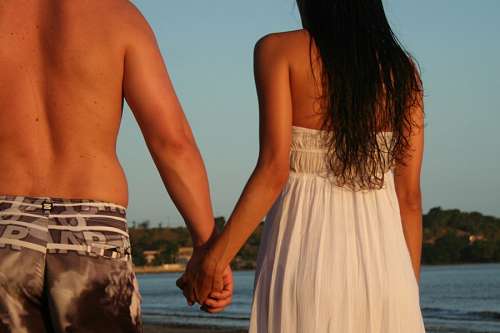 Couple on the beach holding hands