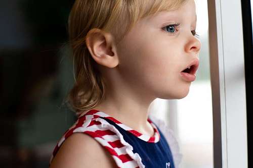 Surprised child looking out the window