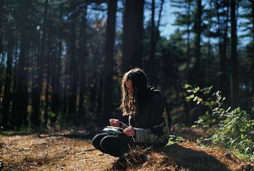 Woman reading at forest