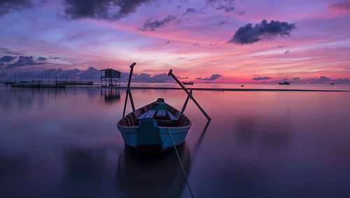Rowboat in a bay at sunset