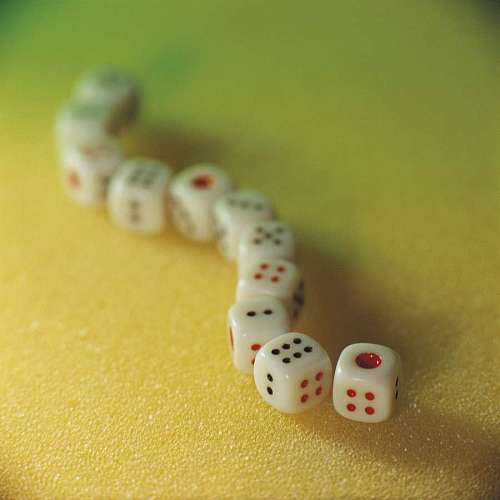 alignment close-up of a pile of dice aligned with a fluffy background