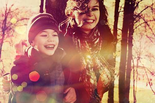 Child smiling next to his mother