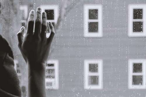 trip Woman's hand on the window while it rains