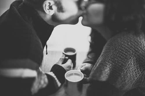 kissing-forehead Couple kissing and drinking coffee