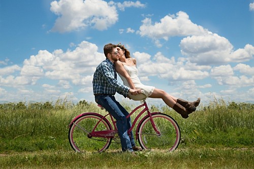 engagement Happy young couple on bike