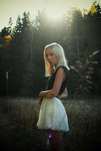 Woman in forest at sunset