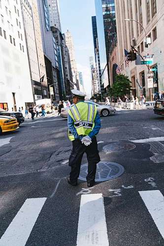 crosswalk traffic police with their backs to the camera