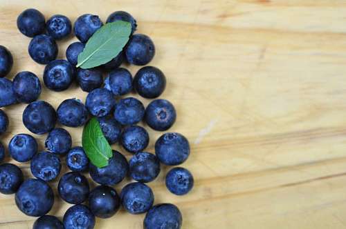 blueberries Top view of blueberries on wooden background