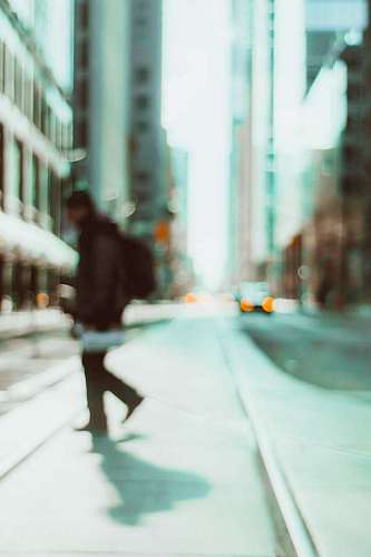 avenue blurred vision of a young man crossing a lonely street