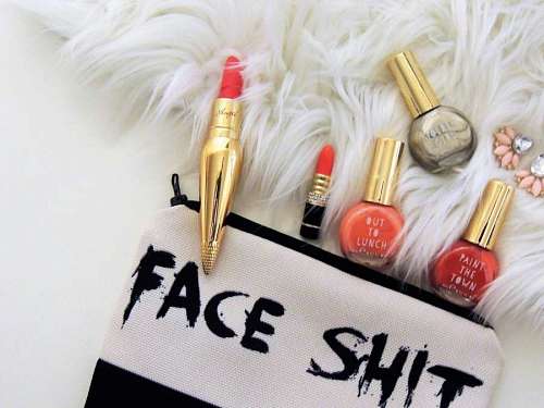 Two Red Lipsticks and Three Assorted-color Nail Polish Bottles