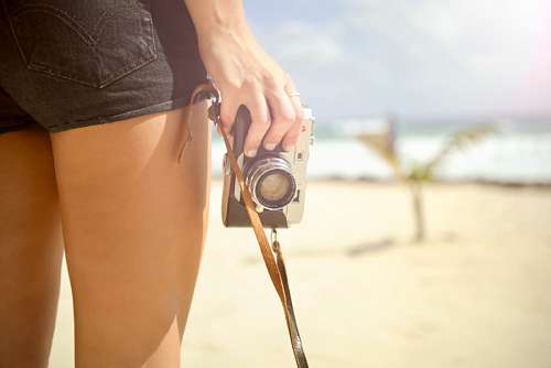 Woman with camera at beach