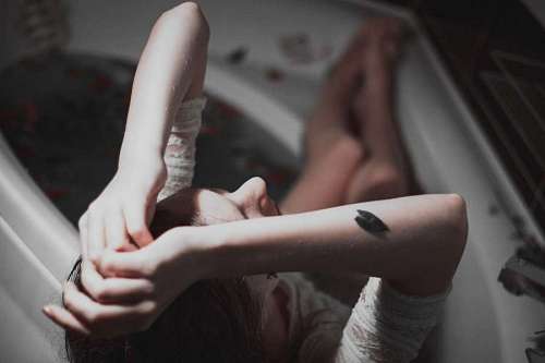 depressed Woman crying in the bathtub