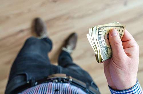 wealth top view of a man withstand dollars