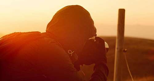 Photographer taking pictures at sunset