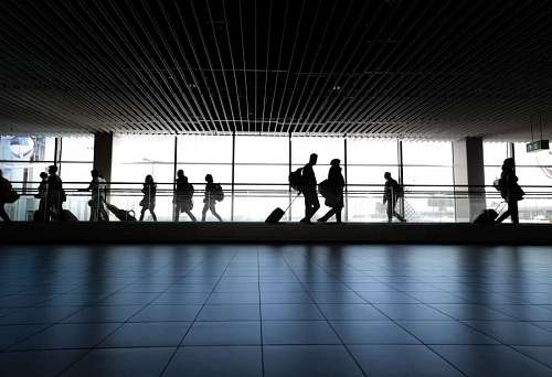 airport-terminal silhouette of people walking from an airport