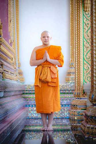Buddhist monk standing in a corner of the temple