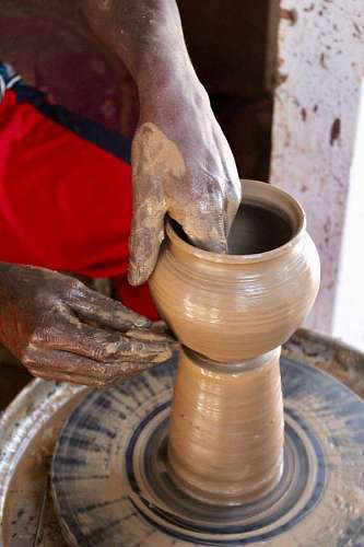 man making a clay pot