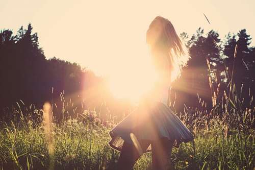 Woman in forest at sunset