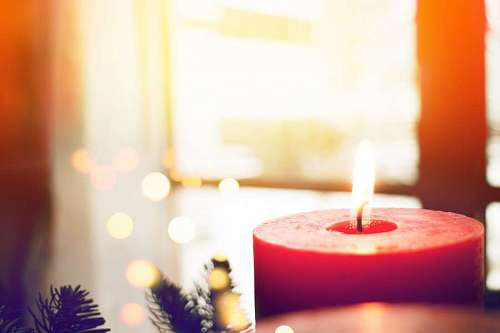 christmastime Burning candle with Christmas background