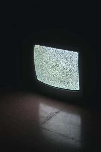 closeup of an old television in the dark