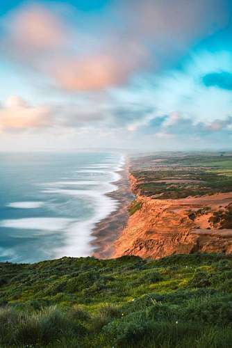 view from a mountain of a cliff on the coast