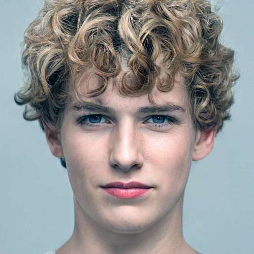 transgender Portrait of a young man with curlers looking at the camera