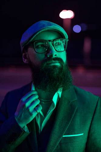  Portrait of a man with a beard and glasses at night
