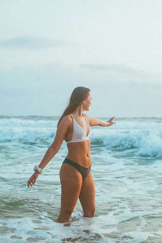 Young woman on the beach enjoying summer