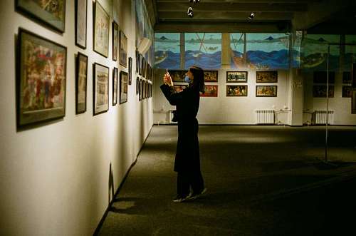 observation A woman looking at paintings in a museum