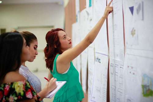 Women taking notes during a meeting in the office