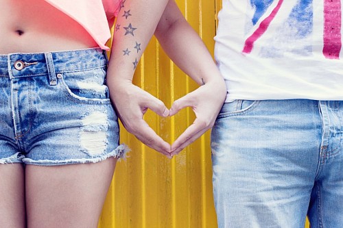 Hands of young forming heart