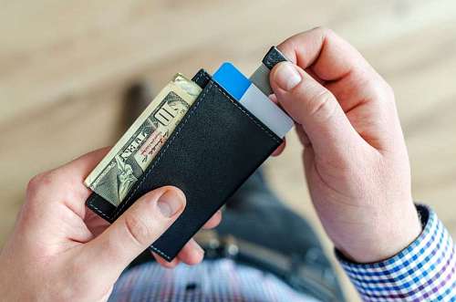 paying-in-store Man taking money out of his wallet to buy in business