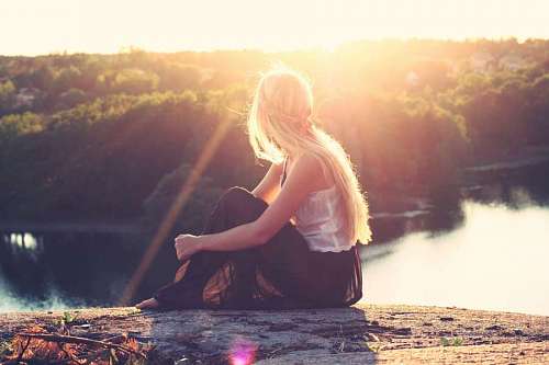 pursuit girl looking to the sunshine with a treescape of background