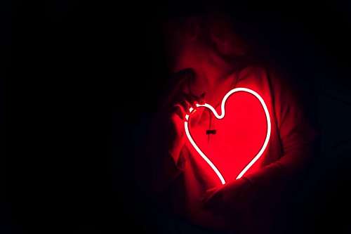 Woman holding light heart led