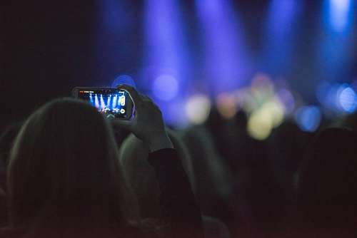 A woman with cellphone in concert