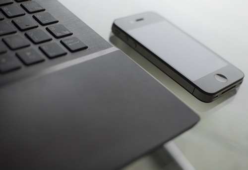 Desk with notebook, note and smartphone