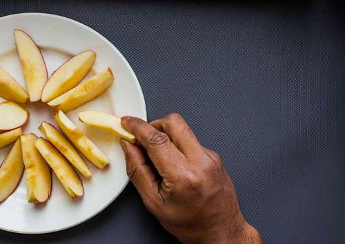 choices  Man's hand holding a slice of fresh apple