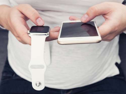Girl using phone and smartwatch