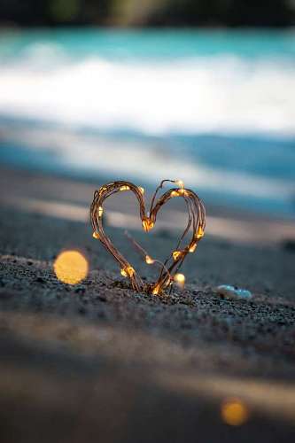Heart illuminated in the sand
