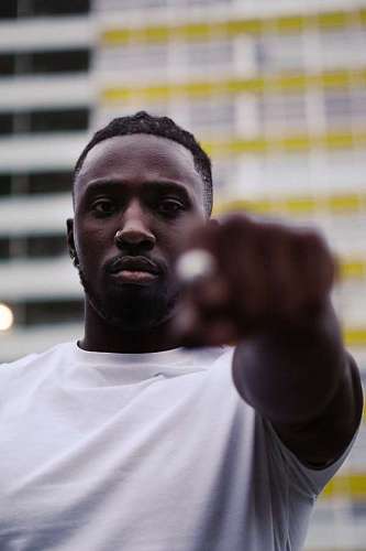 shorts Young man with fist pointing to the front