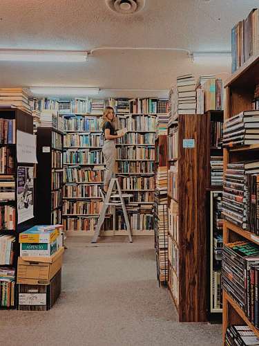 woman arranging books in the background of the library