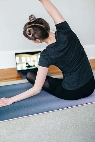 trainer Young woman doing yoga class by video call