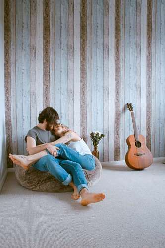 wife Young couple embracing in the living room of their house