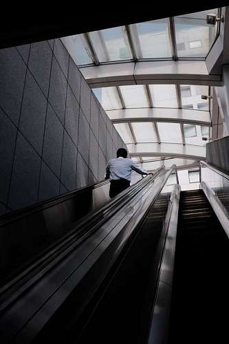lonely man going up the escalator